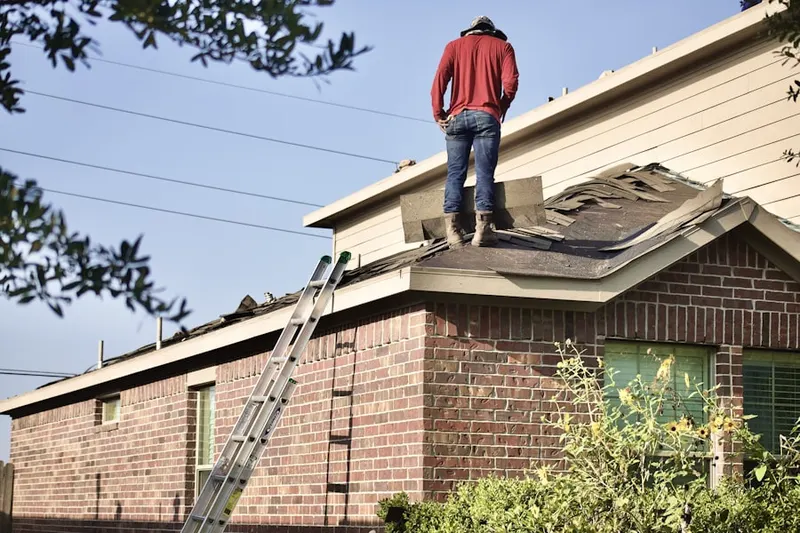 Professional roofer working on a residential roof in Bedford Estates